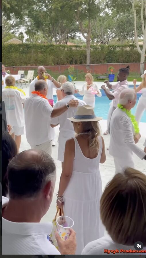 Crowd celebrating poolside at an event